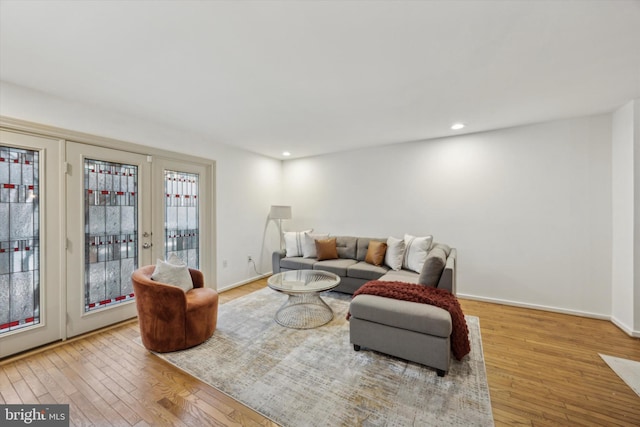 living room with french doors and light hardwood / wood-style floors