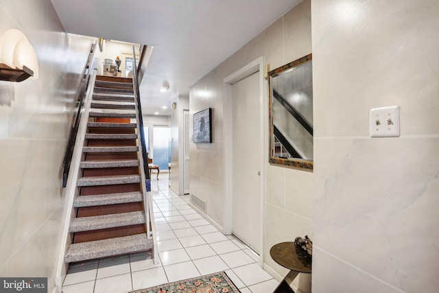 stairway featuring tile patterned flooring