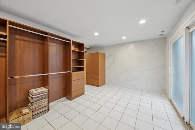 walk in closet with light tile patterned floors