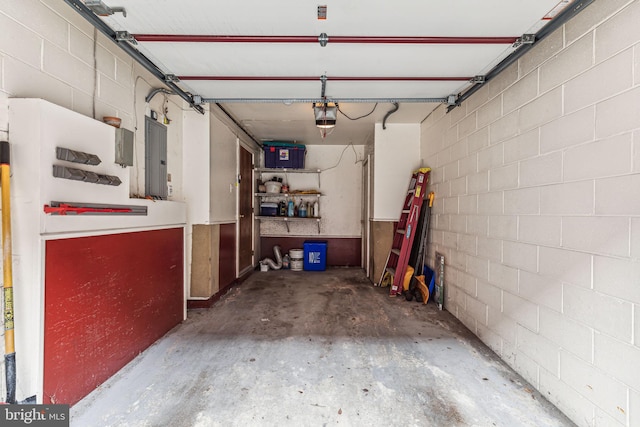 garage with electric panel and a garage door opener