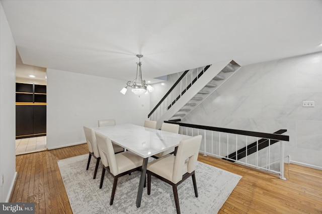 dining room with a chandelier and light wood-type flooring