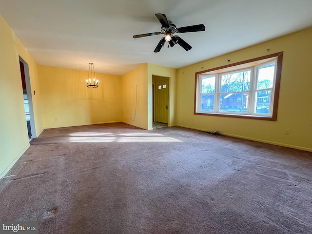 interior space featuring carpet flooring and ceiling fan with notable chandelier