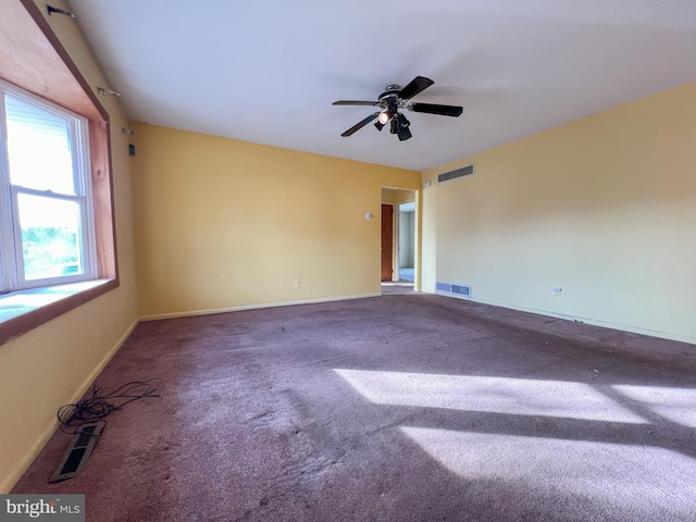 carpeted spare room featuring ceiling fan