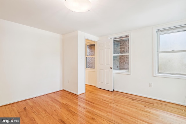 empty room with wood finished floors and baseboards