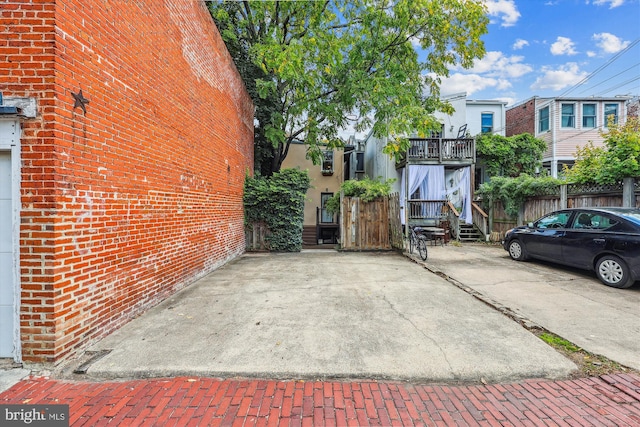 exterior space with brick siding and fence