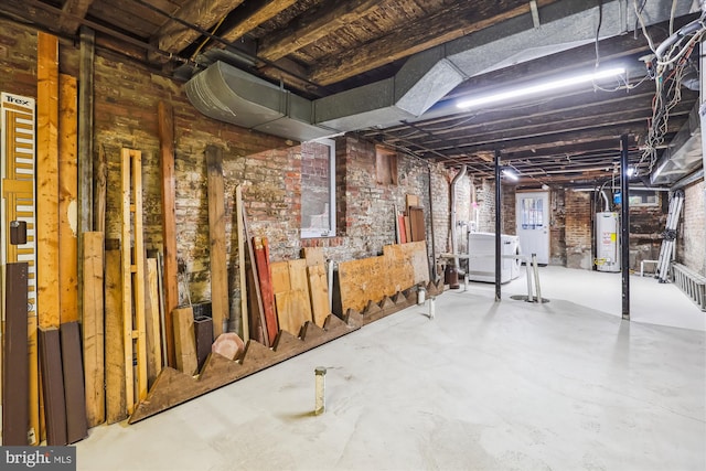 unfinished below grade area featuring brick wall and gas water heater