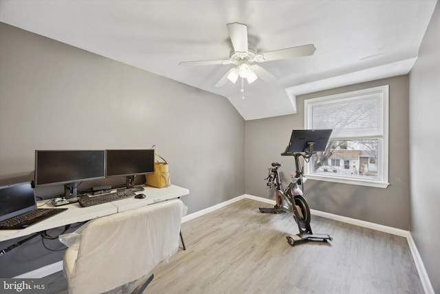 office space featuring ceiling fan, light hardwood / wood-style flooring, and vaulted ceiling