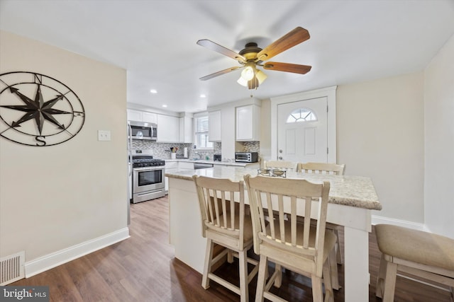 interior space with hardwood / wood-style floors and ceiling fan