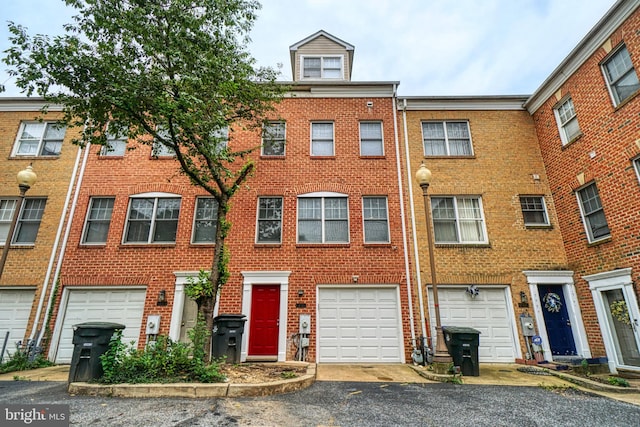 863 Barnaby St SE, Washington, DC 20032 - townhome / multi-family property featuring brick siding, driveway, and a garage