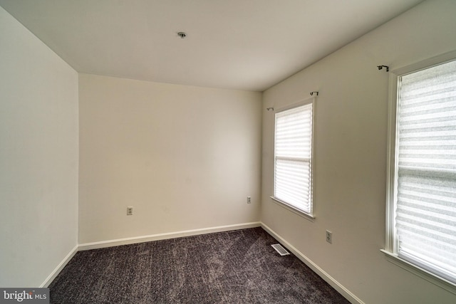 863 Barnaby St SE, Washington, DC 20032 - empty room with dark carpet and a pendent fire sprinkler
