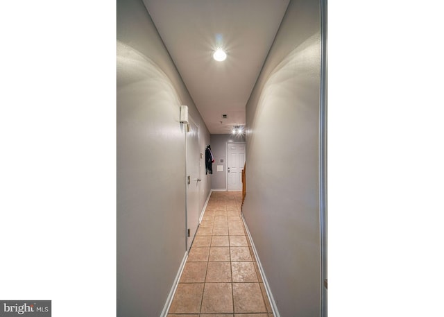 hall featuring light tile patterned floors