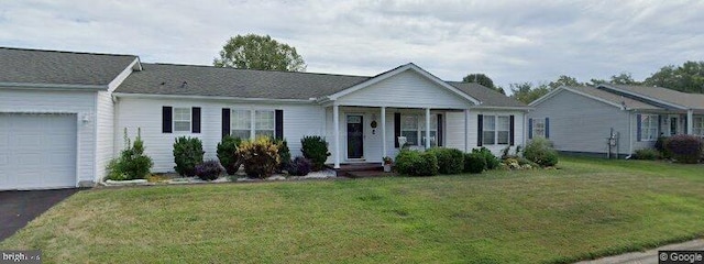 ranch-style house featuring a garage and a front lawn