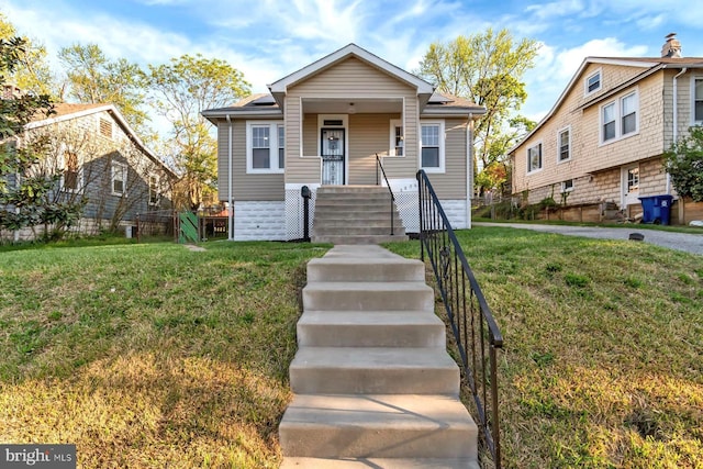 bungalow-style home with a porch and a front yard