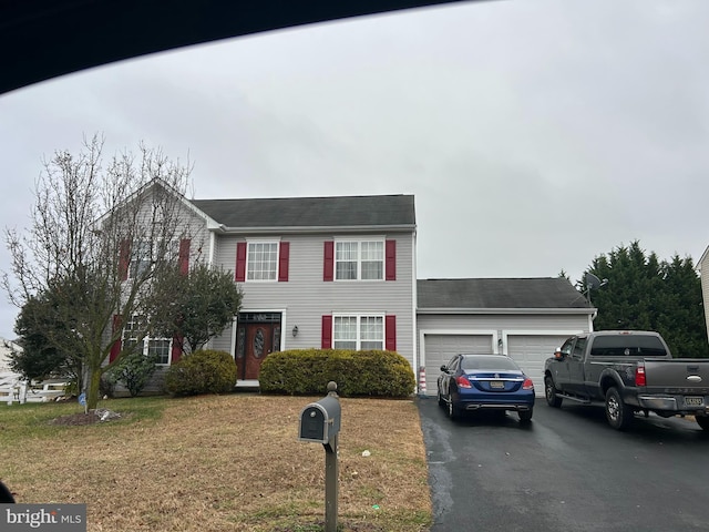 view of front of home featuring a garage and a front lawn