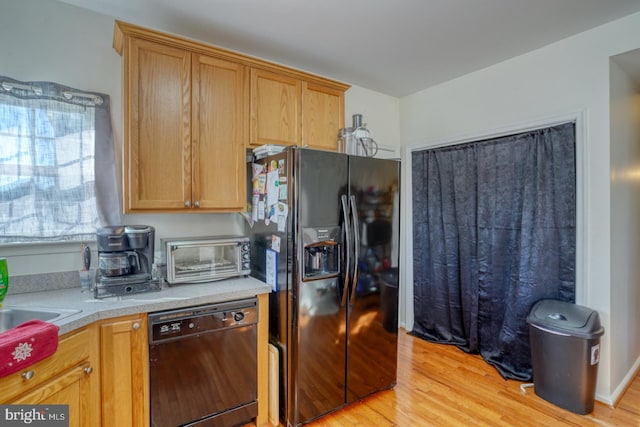 kitchen with black appliances and light wood-type flooring