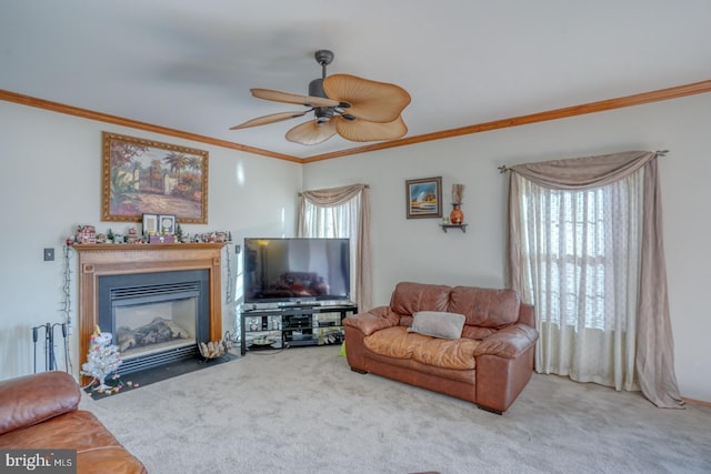 living room featuring ceiling fan, carpet floors, and ornamental molding