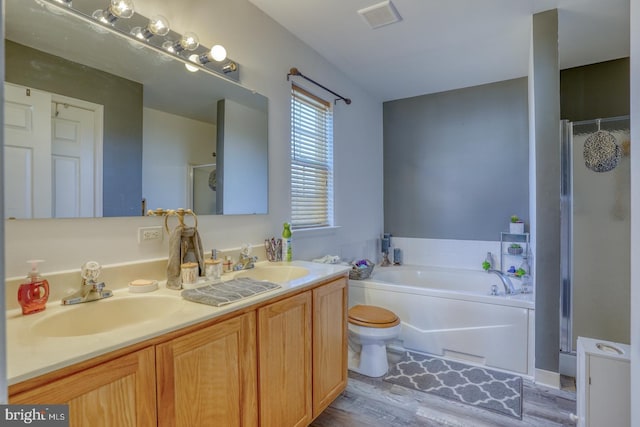 full bathroom with vanity, separate shower and tub, toilet, and wood-type flooring