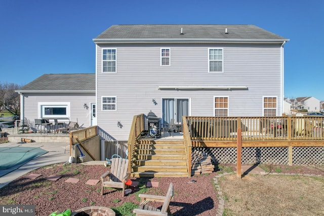 rear view of house featuring a patio area and a swimming pool side deck