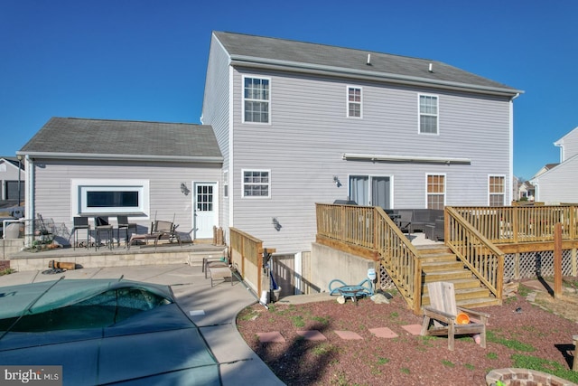 rear view of property with a wooden deck