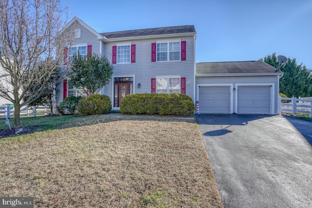 view of front of property featuring a garage and a front lawn