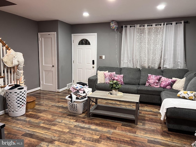 living room featuring dark wood-type flooring