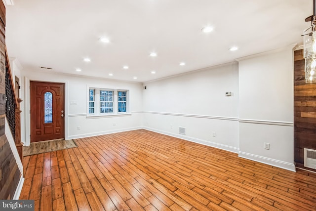 interior space with light wood-type flooring and ornamental molding