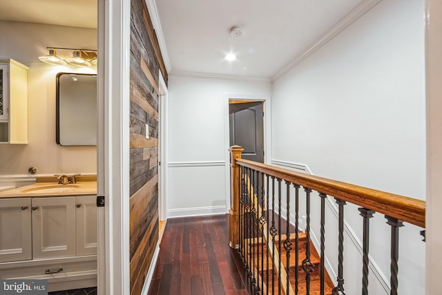 hallway featuring dark hardwood / wood-style floors, crown molding, and sink