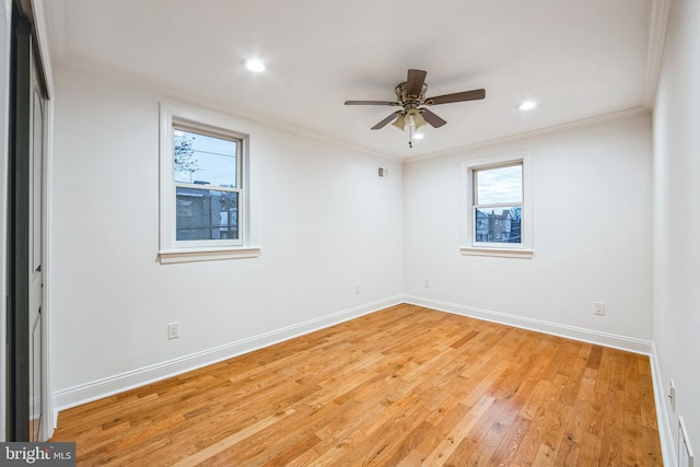 spare room featuring ceiling fan, light wood-type flooring, and ornamental molding