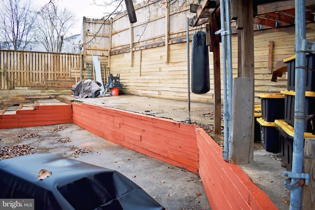 wooden terrace featuring a patio area