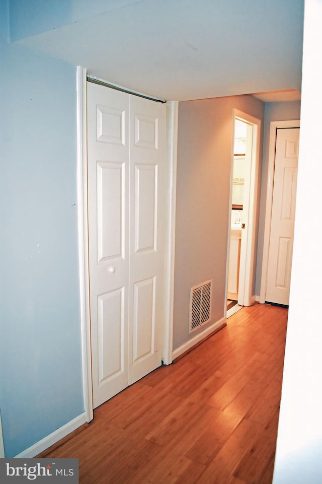 unfurnished bedroom featuring light wood-type flooring and a closet