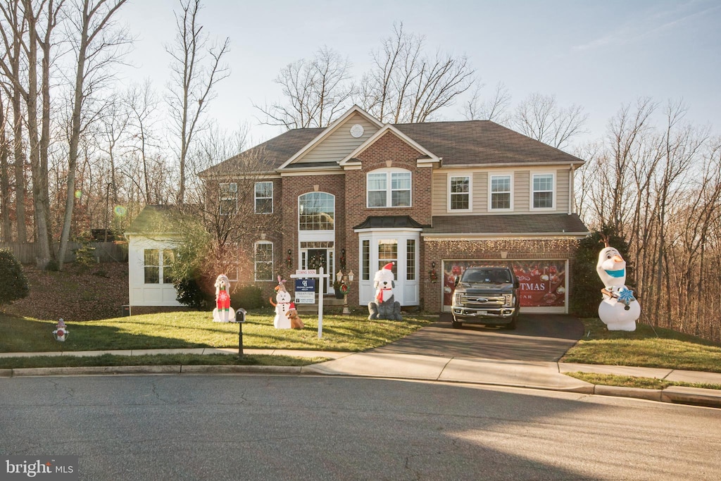 view of front of house with a front yard and a garage