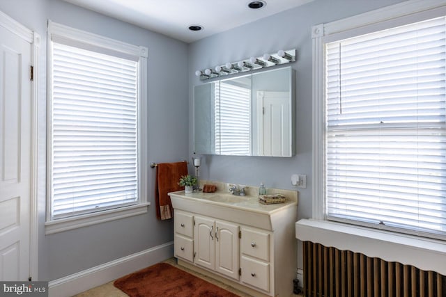 bathroom with radiator heating unit and vanity