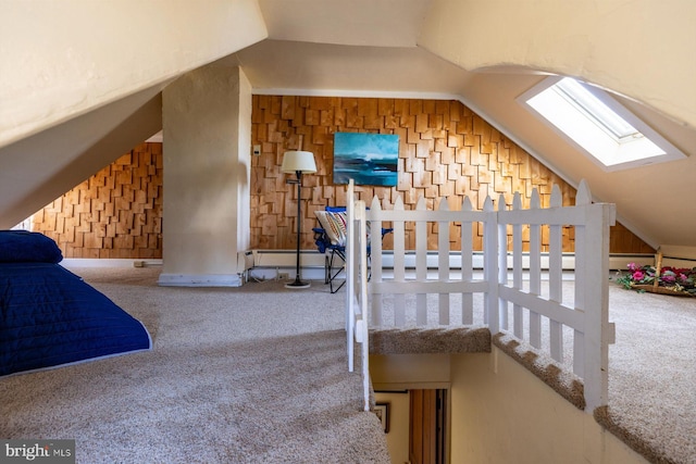 carpeted bedroom featuring lofted ceiling with skylight