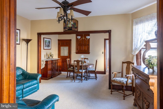 dining area featuring light carpet and ceiling fan