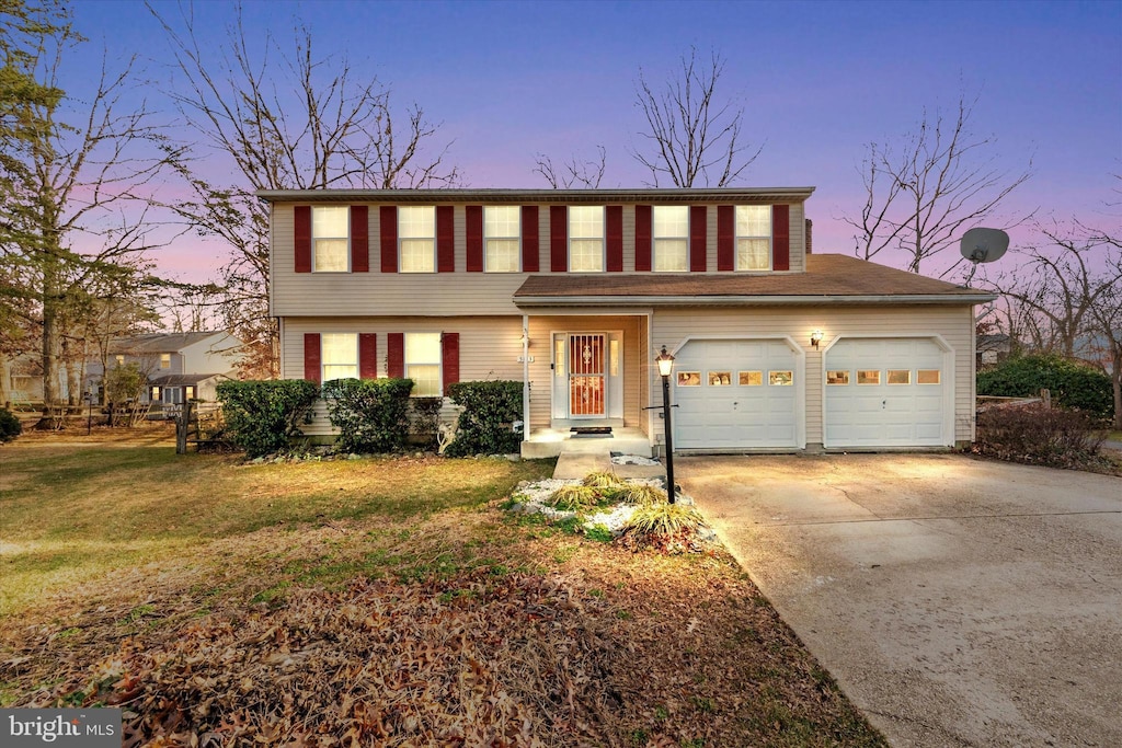 view of front of house with a lawn and a garage