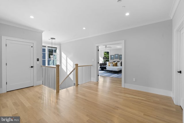 foyer with crown molding and light wood-type flooring