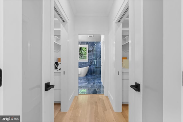 hall with hardwood / wood-style flooring and tile walls