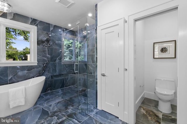 bathroom with separate shower and tub, toilet, and tile walls