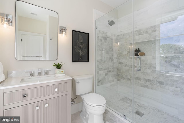 bathroom with vanity, toilet, and an enclosed shower