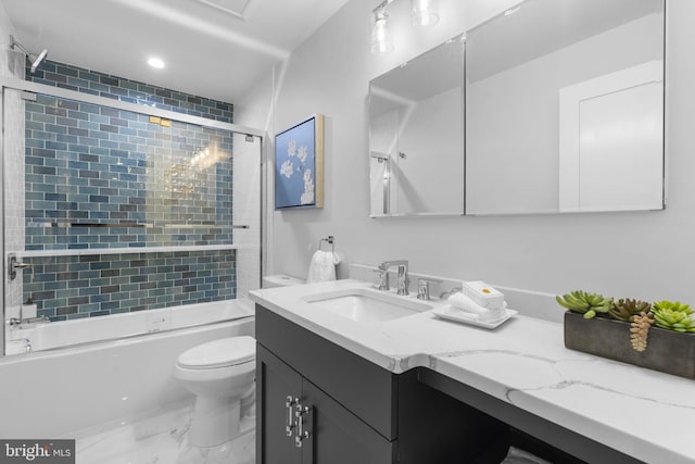 full bathroom featuring shower / bath combination with glass door, vanity, and toilet