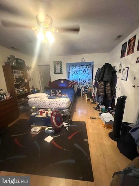 bedroom with hardwood / wood-style floors and ceiling fan