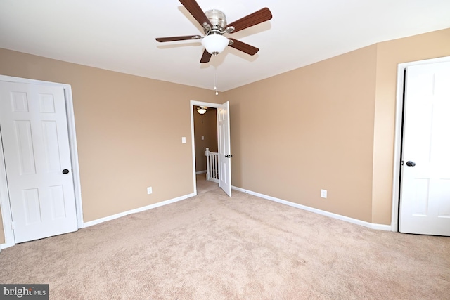 unfurnished bedroom featuring ceiling fan and light carpet