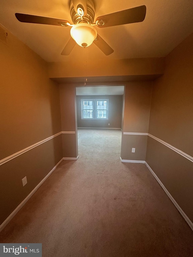 empty room with ceiling fan and carpet floors