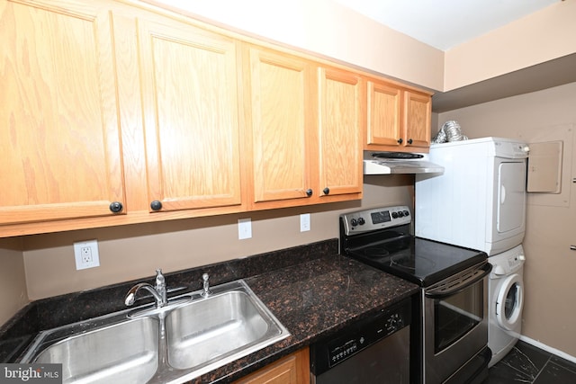 kitchen with sink, stacked washing maching and dryer, dark stone countertops, and appliances with stainless steel finishes