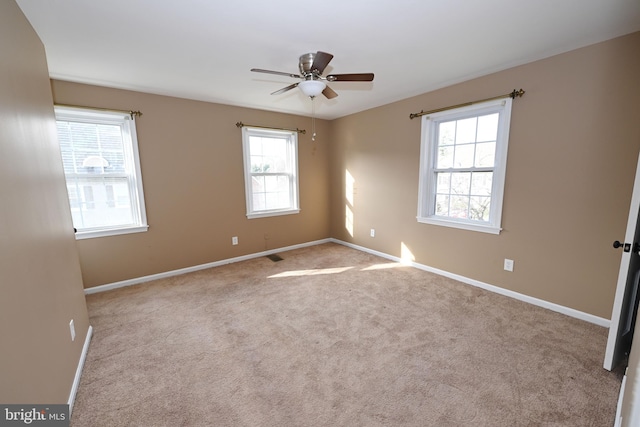 empty room with light carpet and ceiling fan