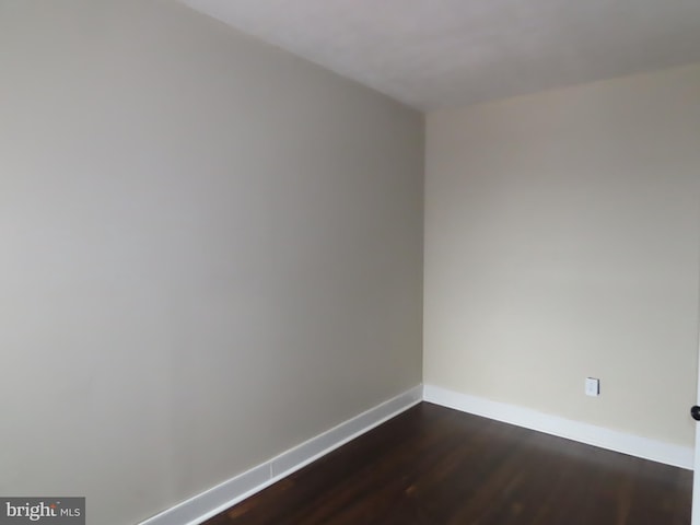 empty room with dark wood-type flooring