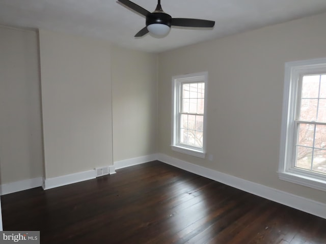 spare room featuring ceiling fan and dark hardwood / wood-style floors