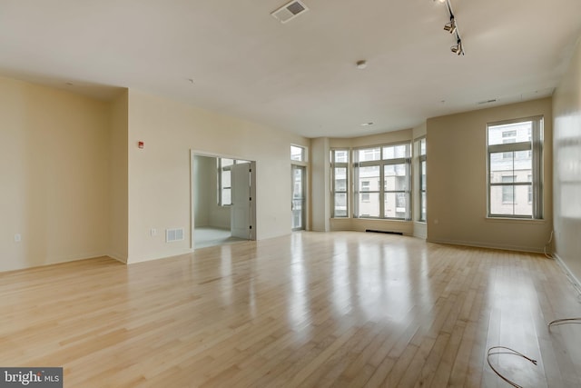 unfurnished room with light wood-type flooring and track lighting