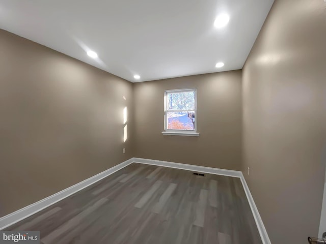 unfurnished room featuring dark hardwood / wood-style floors