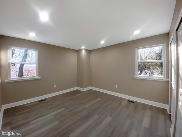 unfurnished room with wood-type flooring